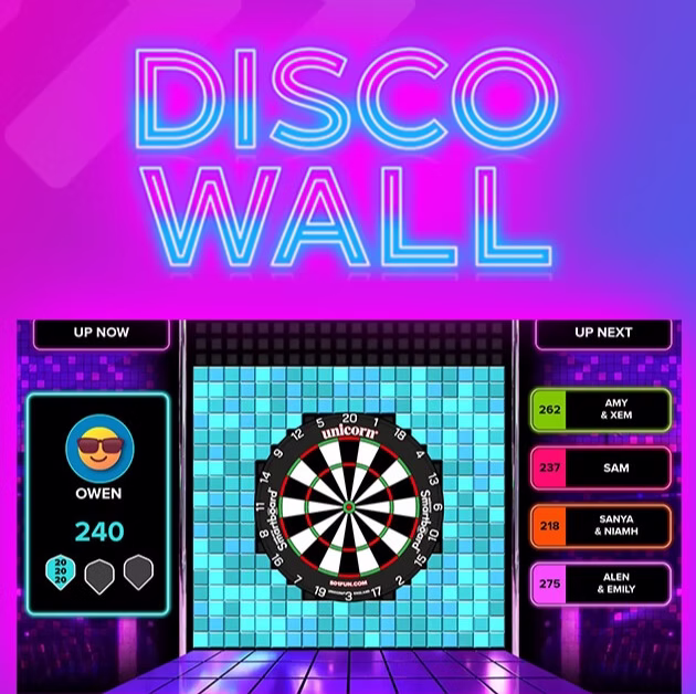 Golfplay A digital game screen titled "Disco Wall" shows a dartboard center stage, player scores on the left, and a queue of upcoming players on the right with neon and disco-themed graphics—perfect for any Golfplay or indoor golf entertainment space. Indoor Golf